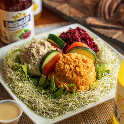 Raw Salad Plate with three colorful dips over sprouts.