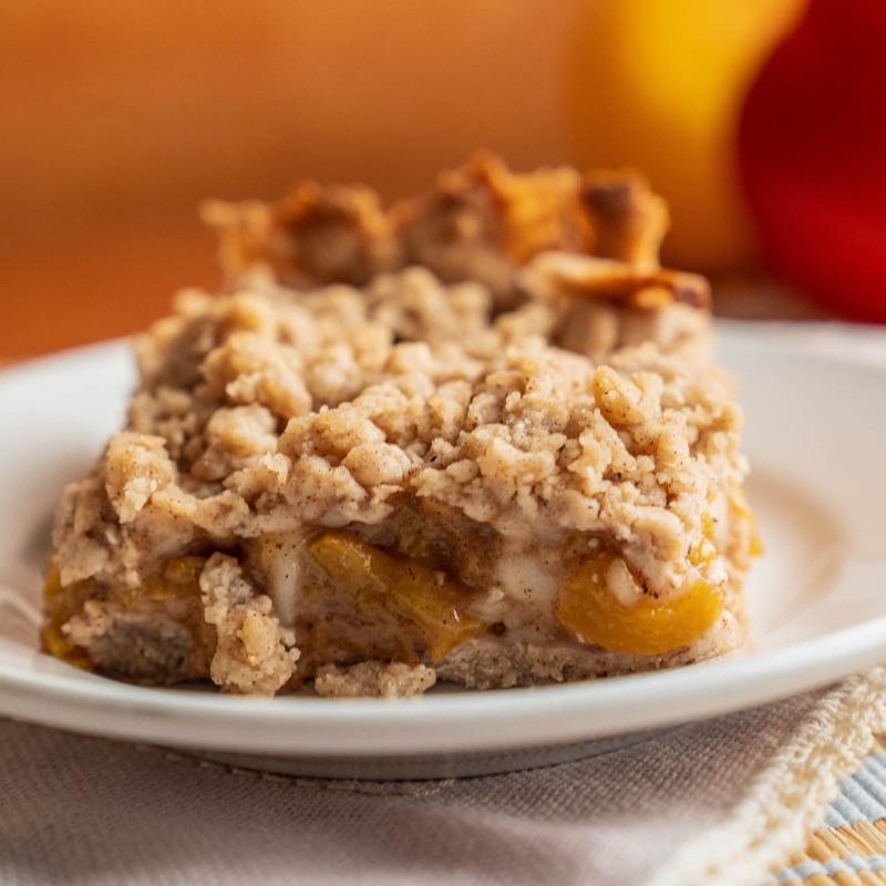 A slice of peach crumble pie.