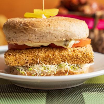 Tofu Sandwich with tomatoes and sprouts.