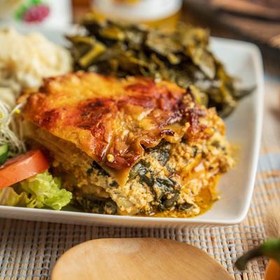 Spinach Lasagna with greens, sprouts, and tomatoes.